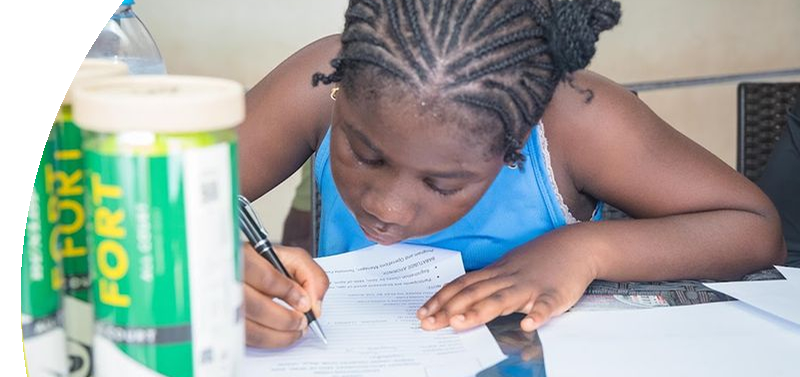 A girl filling in an application at a table