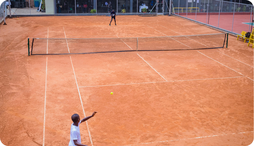 A player serving on a clay court, seen from above