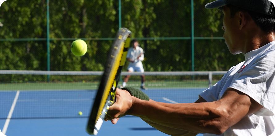 A player hitting a forehand on a blue court