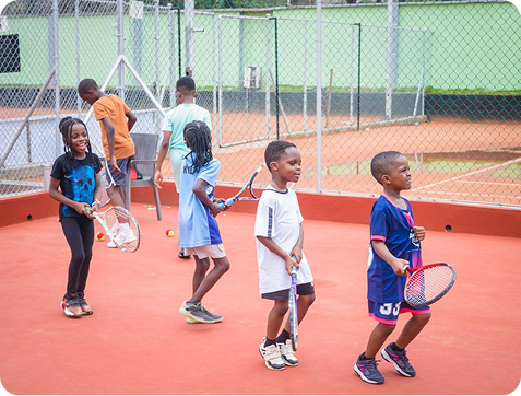 Children with rackets at a tennis clinic
