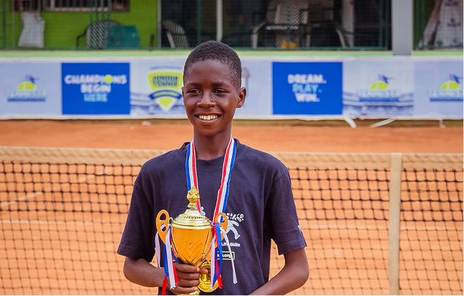 A player holding a trophy and medals