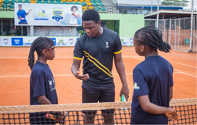 A coach talking with two players